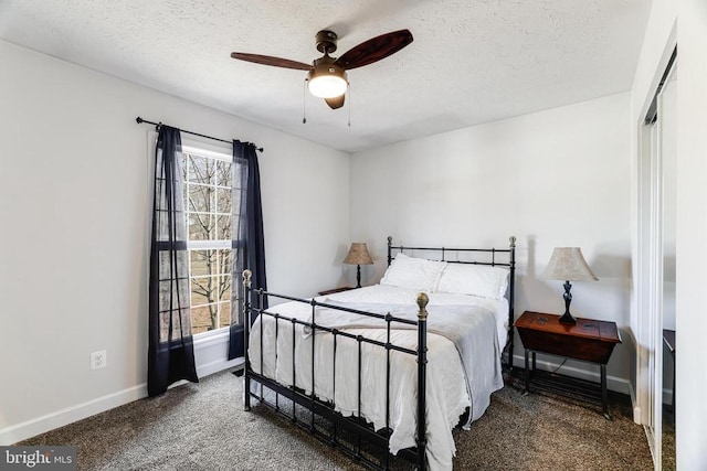  - bedroom featuring carpet floors, a textured ceiling, and a ceiling fan