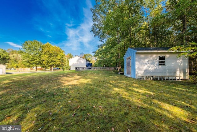  - view of green lawn with a storage shed