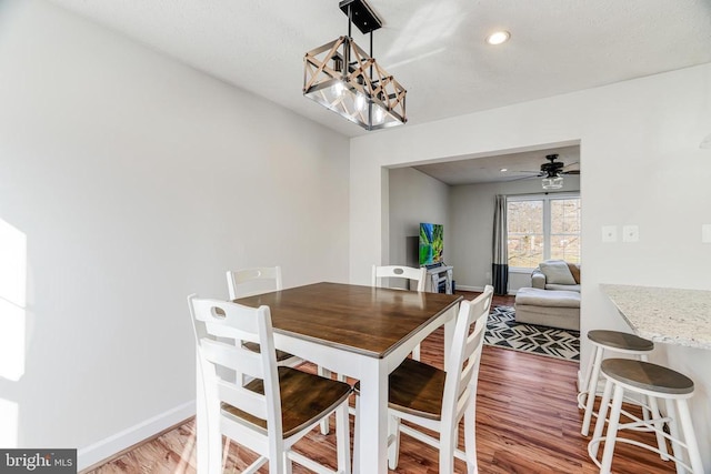  - dining room with wood finished floors, a chandelier, and ceiling fan