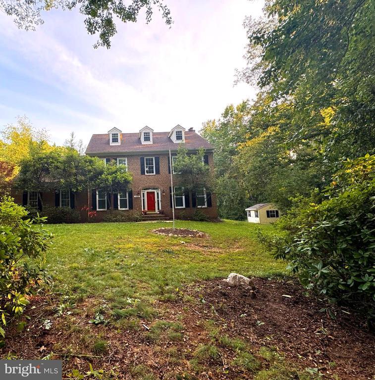 13414 Fox Chase Ln, Spotsylvania, VA 22553 - view of front facade featuring a front lawn, brick siding, and an outdoor structure