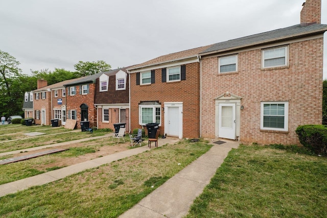 1333 Devon Ln, Harrisonburg, VA 22801 - view of property with a chimney, a front lawn, and brick siding