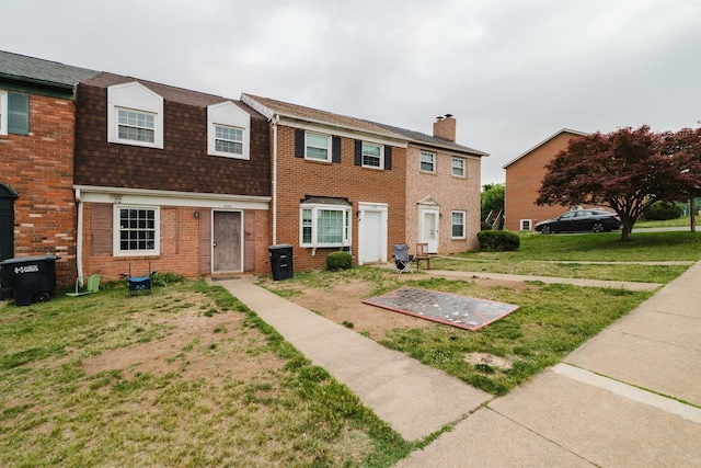 1333 Devon Ln, Harrisonburg, VA 22801 - view of front of home with a front lawn, a chimney, and brick siding