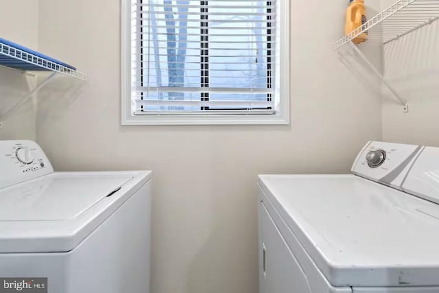 clothes washing area with laundry area and washing machine and clothes dryer