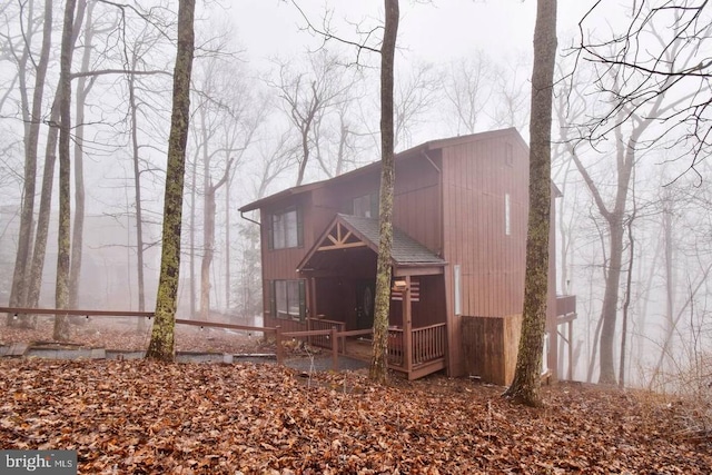 back of property featuring a shingled roof