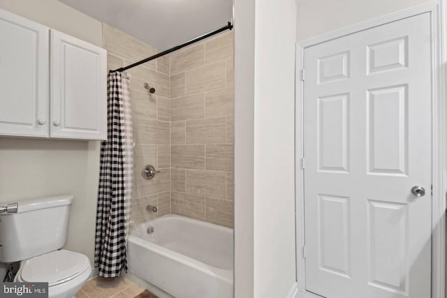 full bathroom featuring tile patterned floors, toilet, and shower / bath combo with shower curtain