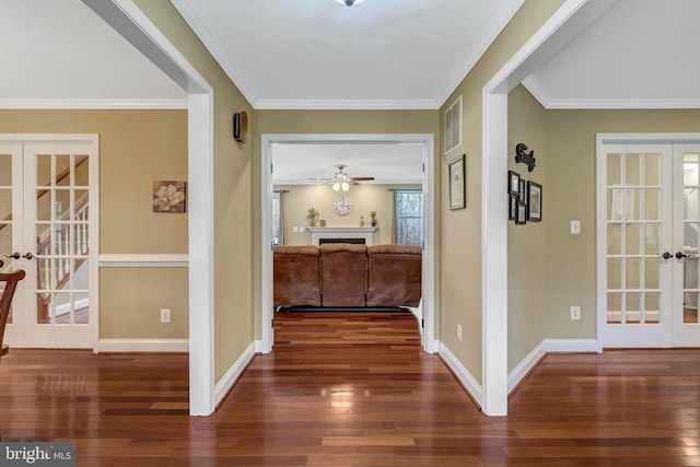  - corridor featuring french doors, wood-type flooring, baseboards, and crown molding