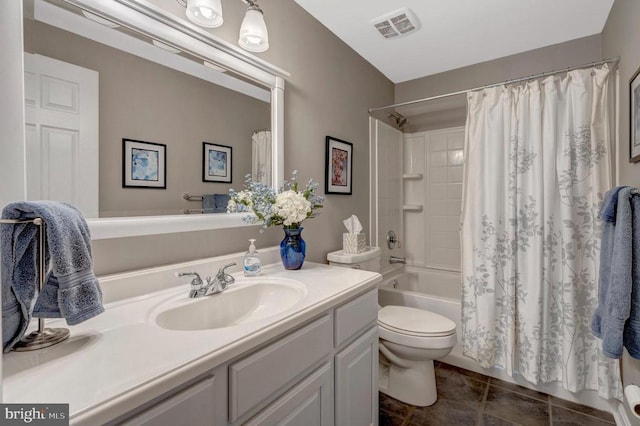  - bathroom featuring tile patterned floors, vanity, shower / bath combo with shower curtain, and toilet