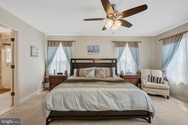  - bedroom featuring light colored carpet, baseboards, and ceiling fan