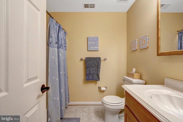  - bathroom with tile patterned floors, vanity, baseboards, and toilet