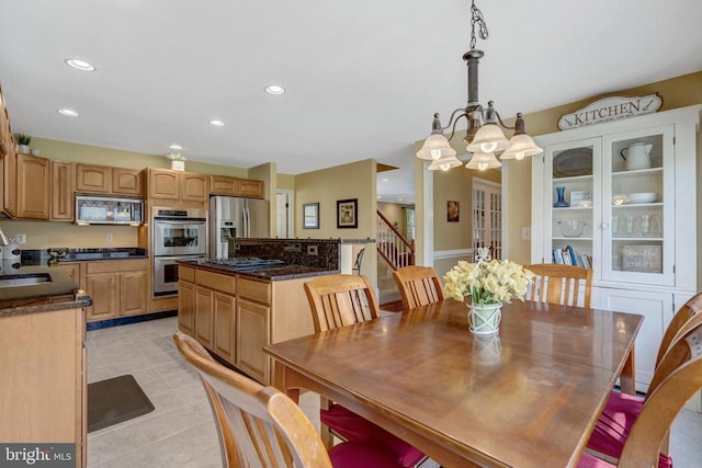  - dining room featuring a chandelier, recessed lighting, light tile patterned flooring, and stairway