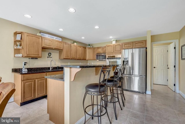  - kitchen featuring stainless steel appliances, a breakfast bar area, a kitchen island, light tile patterned floors, and recessed lighting