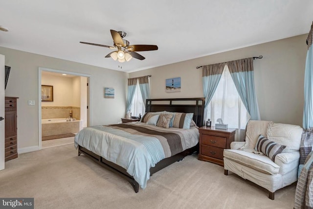  - bedroom featuring light colored carpet, ensuite bathroom, and ceiling fan