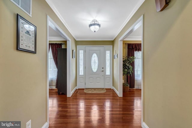  - foyer with hardwood / wood-style flooring, baseboards, and crown molding