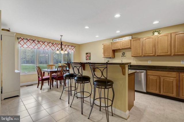  - kitchen with dishwasher, a breakfast bar, recessed lighting, plenty of natural light, and dark countertops