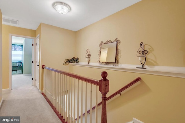  - hall with carpet, an upstairs landing, and baseboards