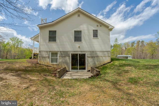  - back of house featuring a yard and a patio area