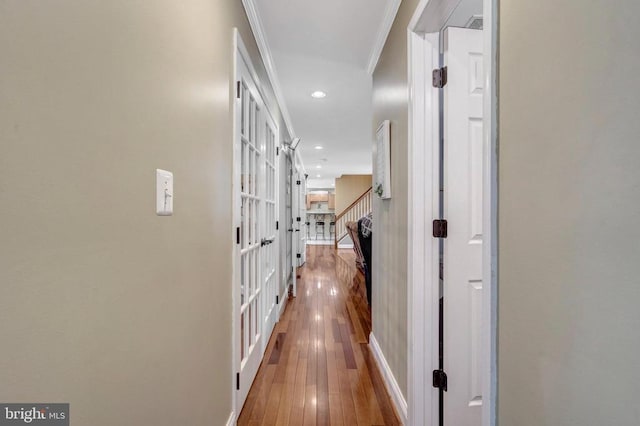  - hall with ornamental molding, recessed lighting, hardwood / wood-style flooring, and baseboards