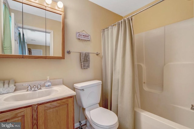  - bathroom featuring toilet, vanity, and shower / bath combo with shower curtain