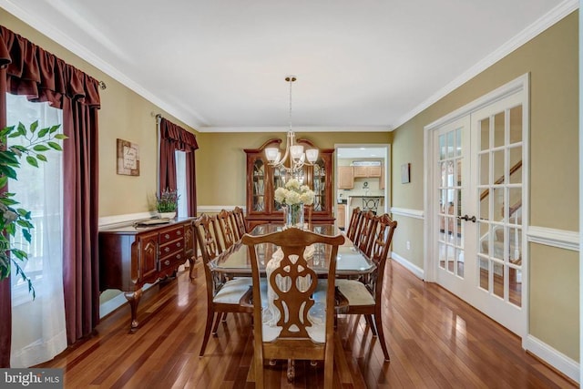  - dining space with wood finished floors, french doors, ornamental molding, and a chandelier