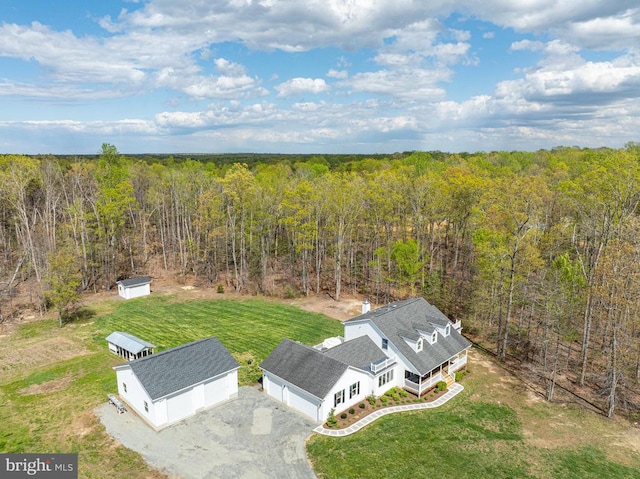  - aerial view of property and surrounding area featuring a heavily wooded area