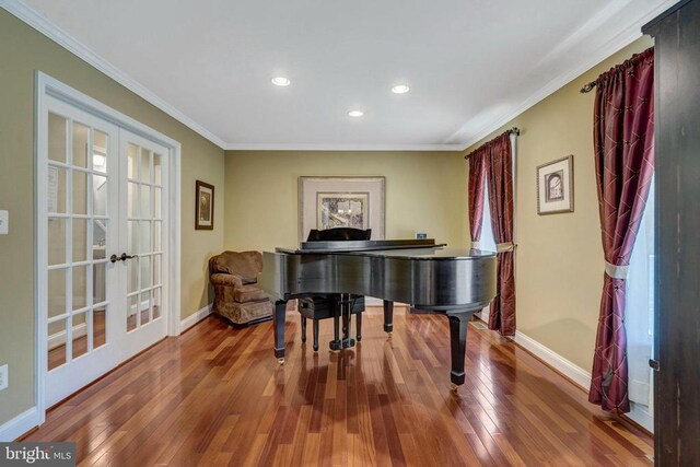  - living area with french doors, hardwood / wood-style flooring, baseboards, ornamental molding, and recessed lighting