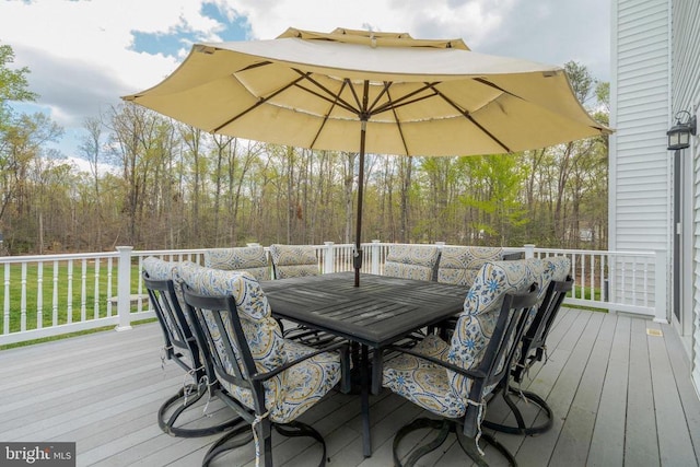  - wooden terrace with outdoor dining space and a lawn