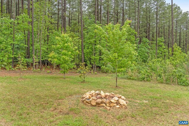 6169 Community House Rd, Columbia, VA 23038 - view of grassy yard featuring a view of trees and an outdoor fire pit