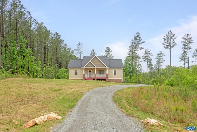 6169 Community House Rd, Columbia, VA 23038 - view of front facade featuring driveway, a front lawn, a porch, and a wooded view