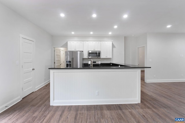 6169 Community House Rd, Columbia, VA 23038 - kitchen with stainless steel appliances, dark countertops, a center island with sink, dark wood-style flooring, and recessed lighting