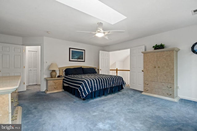  - carpeted bedroom featuring a ceiling fan, a skylight, and baseboards