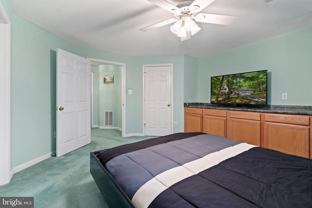  - bedroom featuring light carpet, baseboards, and ceiling fan