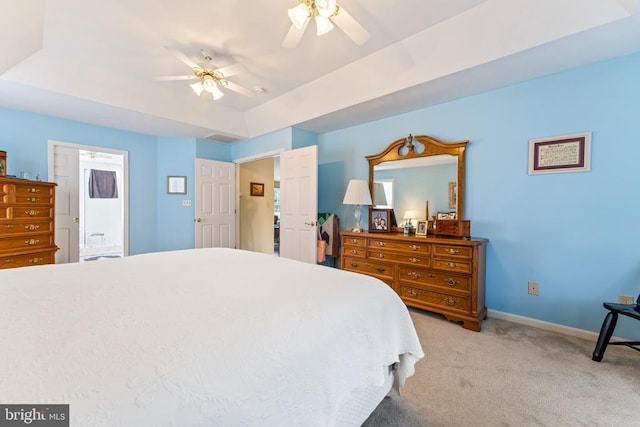12219 Glade Dr, Fredericksburg, VA 22407 - bedroom with light colored carpet, baseboards, a raised ceiling, a ceiling fan, and connected bathroom