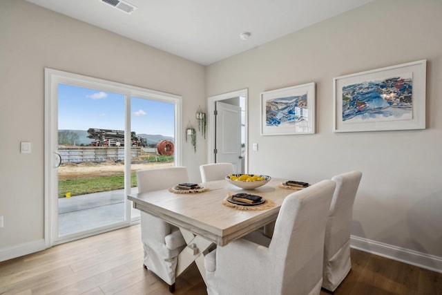 14767 Green View Dr, Elkton, VA 22827 - dining area with light wood-type flooring, visible vents, and baseboards