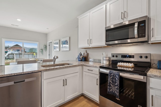 14767 Green View Dr, Elkton, VA 22827 - kitchen with a sink, white cabinets, light stone countertops, appliances with stainless steel finishes, and recessed lighting