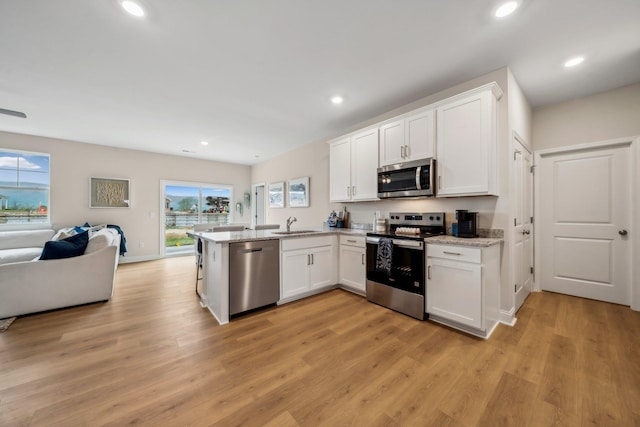 14767 Green View Dr, Elkton, VA 22827 - kitchen with a peninsula, stainless steel appliances, open floor plan, and white cabinets