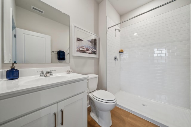 14767 Green View Dr, Elkton, VA 22827 - full bathroom featuring toilet, visible vents, tiled shower, vanity, and wood finished floors