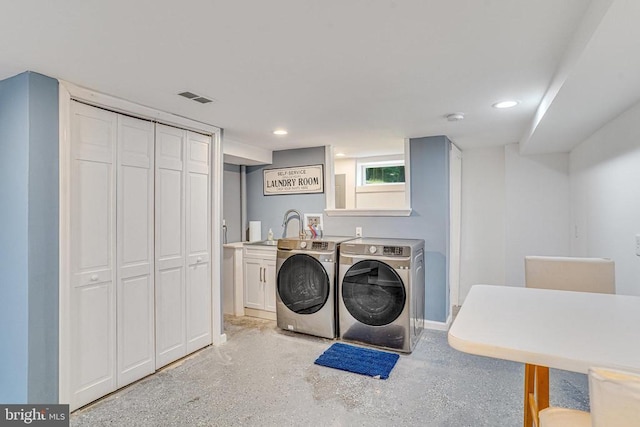  - laundry area featuring independent washer and dryer, cabinet space, and recessed lighting