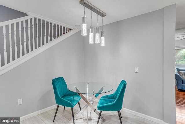  - dining space featuring stairway and wood finished floors