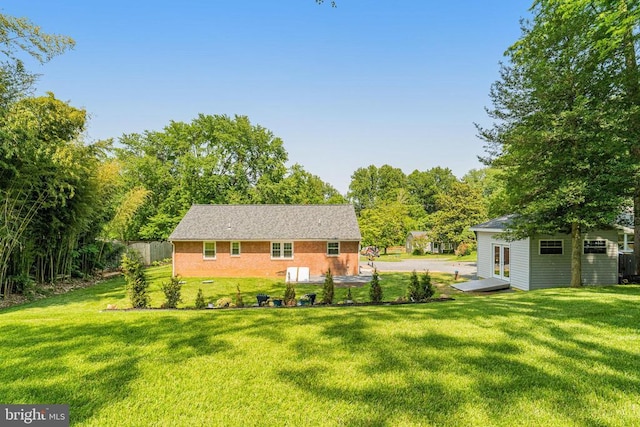  - rear view of property featuring brick siding and an outbuilding