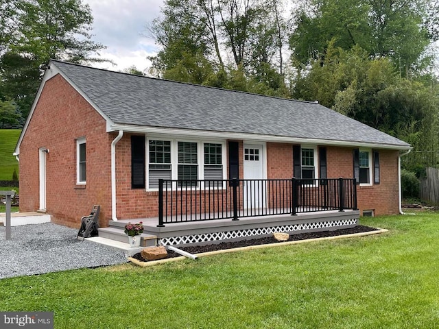 - ranch-style house featuring a shingled roof, brick siding, a porch, and a front lawn