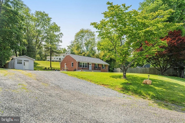  - ranch-style home featuring a storage unit and a detached garage