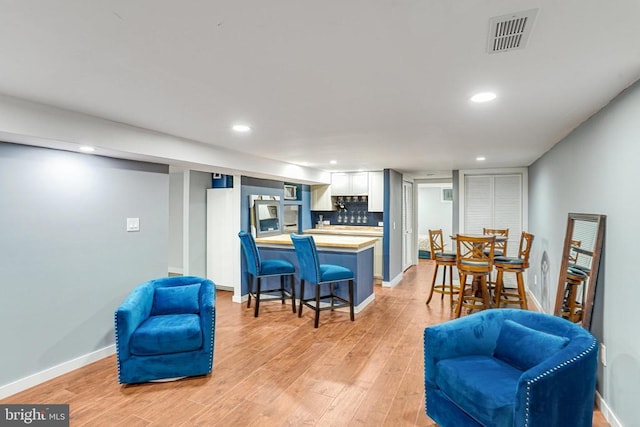  - living area featuring recessed lighting and light wood finished floors