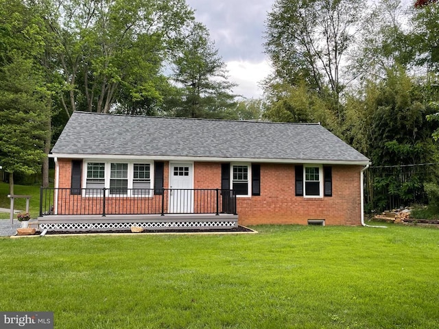  - view of front of house featuring brick siding, roof with shingles, and a front yard