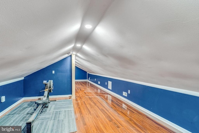  - bonus room featuring vaulted ceiling, wood finished floors, a textured ceiling, and recessed lighting