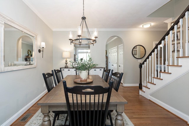 21 Spring View Dr, Staunton, VA 24401 - dining area featuring arched walkways, a chandelier, wood finished floors, stairs, and ornamental molding