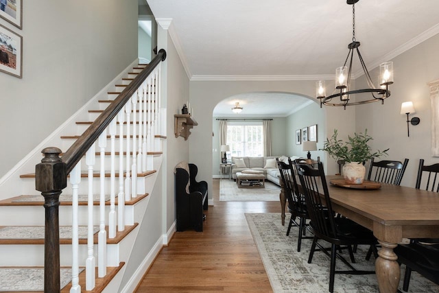 21 Spring View Dr, Staunton, VA 24401 - dining room featuring arched walkways, ornamental molding, wood finished floors, a chandelier, and stairs