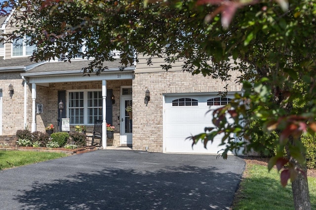 21 Spring View Dr, Staunton, VA 24401 - view of front facade featuring driveway, a porch, brick siding, and an attached garage