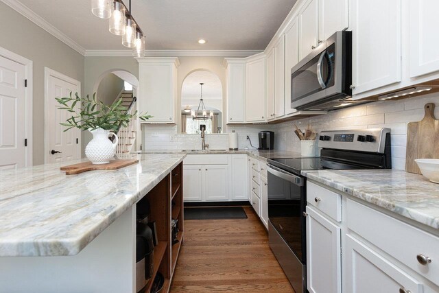 21 Spring View Dr, Staunton, VA 24401 - kitchen with appliances with stainless steel finishes, a sink, white cabinets, ornamental molding, and arched walkways