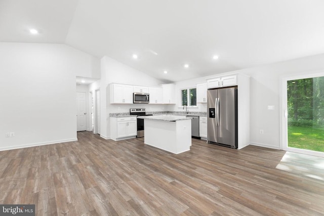 Hensley Rd, Mineral, VA 23117 - kitchen featuring stainless steel appliances, a center island, lofted ceiling, white cabinetry, and light wood-style flooring