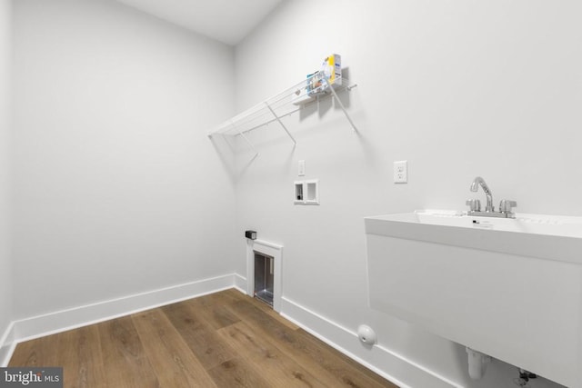 885 Buckners Ln, Compass Cove At Lake Anna Mineral, VA 23117 - washroom with baseboards, a sink, washer hookup, wood finished floors, and laundry area